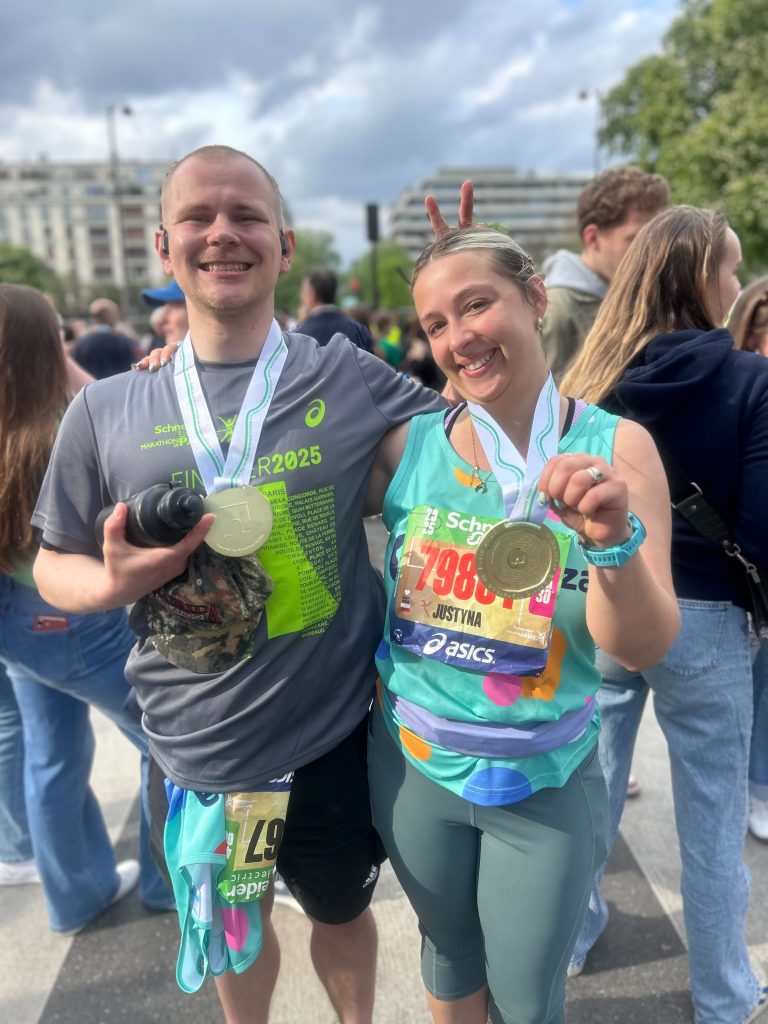 Milo and Justyna from Comparison Tech show off their Paris Marathon medals.